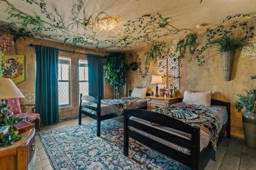 a bedroom with two beds and a desk and a room at Stay at Hogwarts Harry Potter's Home, Free Parking, Pets Allowed in Kissimmee