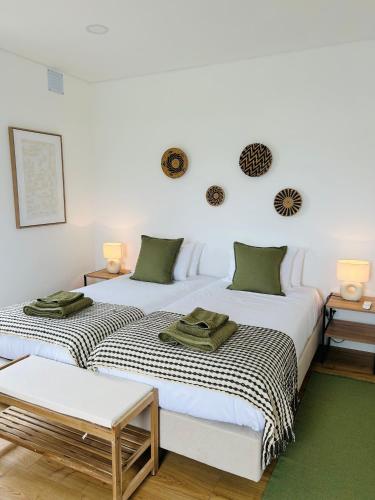 two beds sitting next to each other in a room at Azorescape in Lagoa