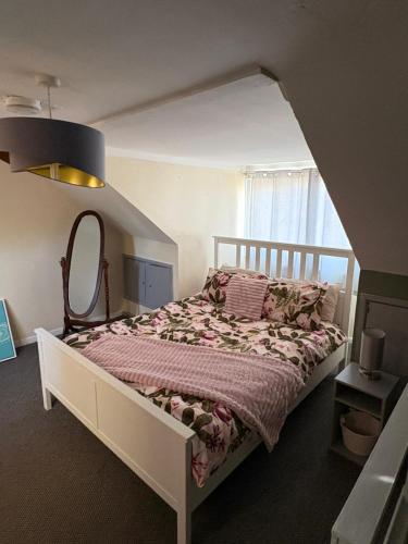 a bedroom with a bed with a large window at stylish new house sleeps 5 max in Swansea
