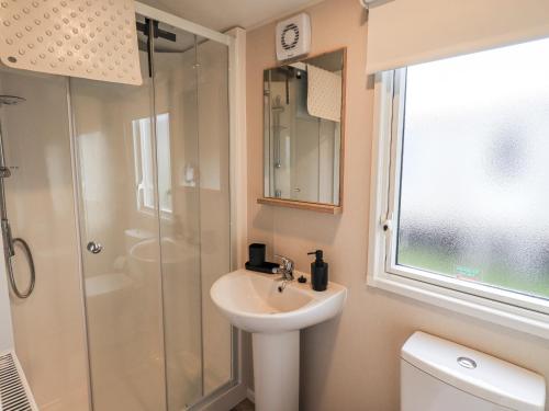 a bathroom with a sink and a shower at Hadrian's Rest Glendale Holiday Park in Wigton