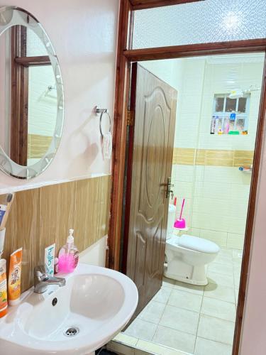 a bathroom with a sink and a toilet at Beytumn Executive Apartment in Ruiru