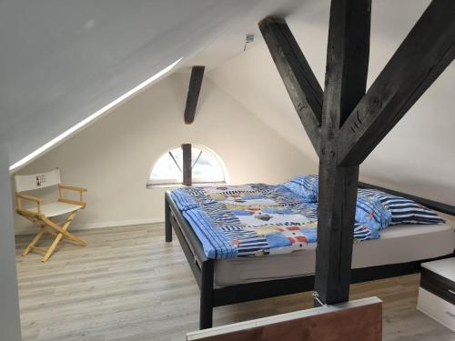 a bedroom with a bed and a wooden floor at Leuchtturmhus in Fürstenberg