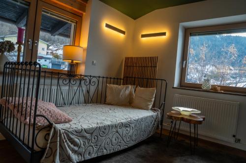 a bedroom with a bed and a window at Berg Glück Axams in Innsbruck
