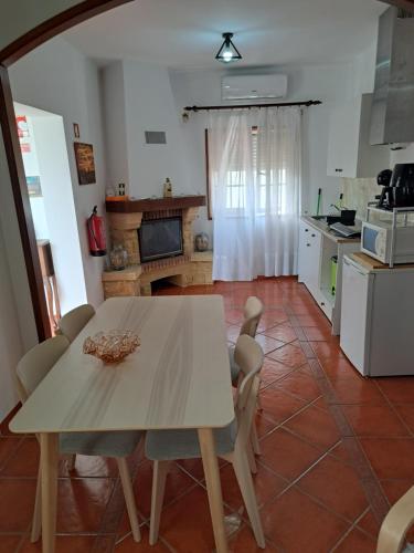 a kitchen with a table and chairs in a room at Casa Azélia e Albino in Aves