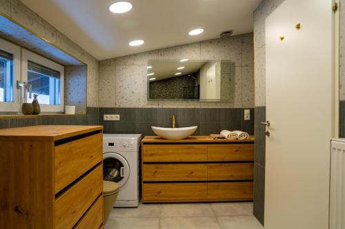 a bathroom with a washing machine and a sink at Berg Glück Axams in Innsbruck