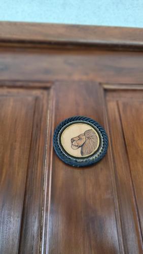 a plate on a wooden door with a dog on it at Ashe Oleng House in Arusha