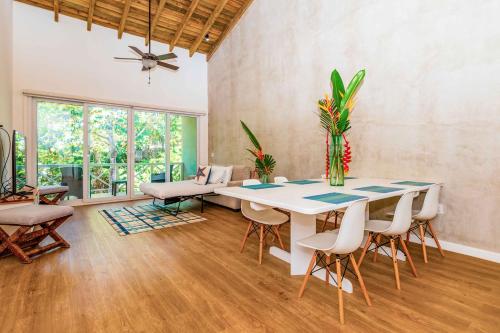 a dining room with a table and chairs at Blue Roatan Resort in West Bay