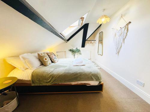 a bedroom with a bed in a attic at Langdale Loft - Whitby in Whitby