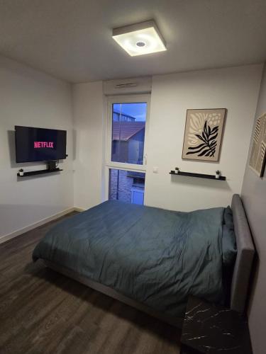 a bedroom with a bed and a tv and a window at Amour x Paris x Netflix x Wheel chair Access in Ivry-sur-Seine