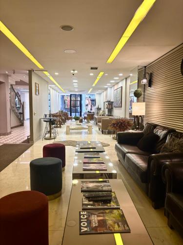 a lobby with a couch and a table with books at Wame Suite Hotel Nisantasi in Istanbul