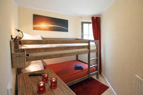 a room with two bunk beds and a table at Chalet Jägerstieg in Braunlage