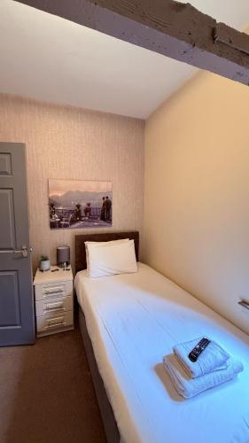 a bedroom with a bed with a remote control on it at Grant House in Boston