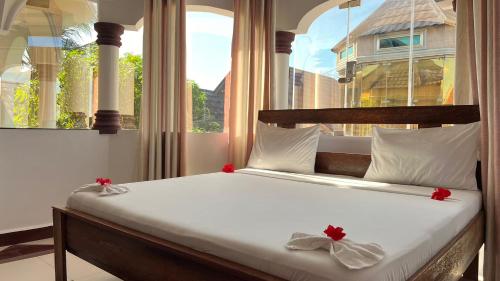 a bed in a room with a large window at skyport villa in Zanzibar City