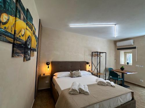a bedroom with a bed with towels on it at Tina House in Siculiana