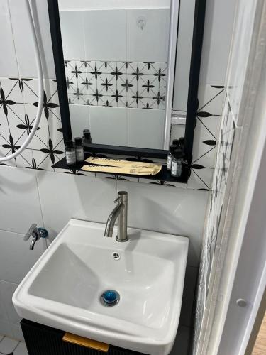 a bathroom with a sink and a mirror at Singgah Dusun Zahra in Kampong Perak