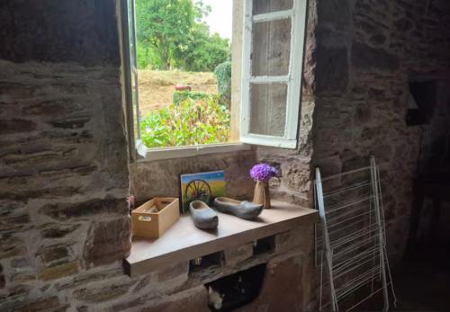 a window in a stone building with a shelf with a window at Gîte Pierre, Beynat, Corrèze in Beynat