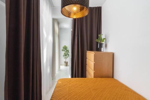 a bedroom with a bed and a chandelier at Nice Bungalow with Two Bedrooms in Adeje