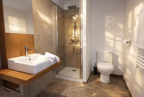 a bathroom with a sink and a shower and a toilet at Pomme d'Happy in Autheux