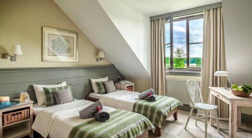 a hotel room with two beds and a window at Sielanka Nad Pilicą in Warka