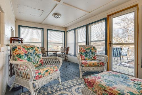 a room with wicker chairs and a table and windows at 3 Mi to Dtwn Monticello! Waterfront Studio Getaway in Monticello
