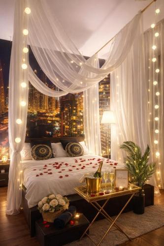 a bedroom with a bed with a view of a city at City Tales Residence in Braşov