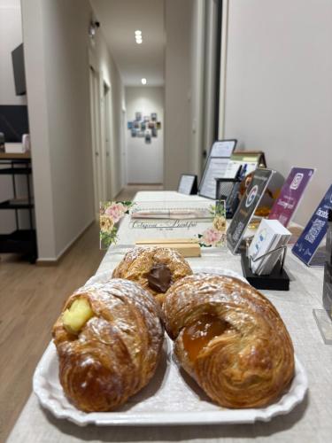 three pastries on a plate on a table at Sogni in Suites in Bari