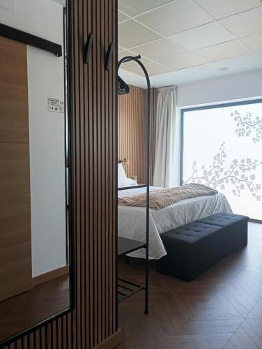 a bedroom with a bed and a large window at Apartamento rural Rubí in El Torno