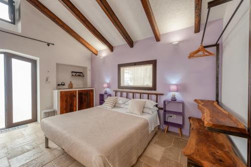 a bedroom with a large bed and two tables at Corte Piri in Tricase
