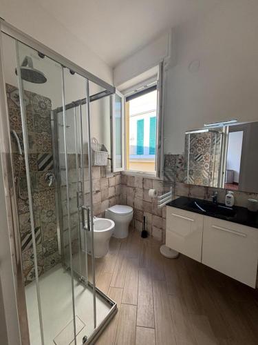 a bathroom with a shower and a toilet and a sink at Appartamento Bixio sul porto in Sanremo