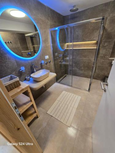 a bathroom with a shower and a sink and a mirror at Infinity Blue Korčula in Korčula