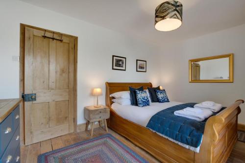 a bedroom with a bed with a blue comforter at 4 Bed in St. Wenn oc-p00886 in Saint Wenn