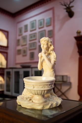 a statue of a woman sitting in a vase on a table at Fort Jangaldhar in Bikaner