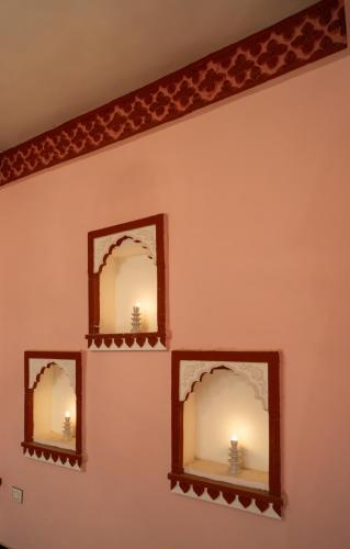 two mirrors on a wall in a room at Fort Jangaldhar in Bikaner