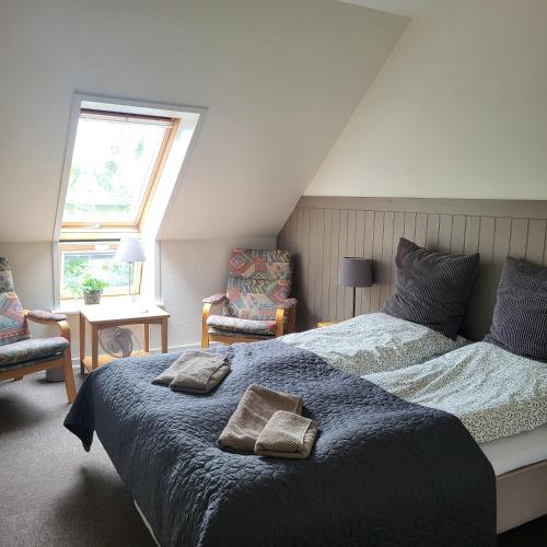 a bedroom with a large bed with two pillows on it at Lysbjerggård in Faaborg