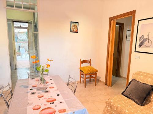 a living room with a table and a couch at Baia Incantata in Baia Verde