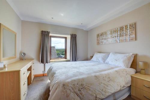 a bedroom with a large bed and a window at 1 Bed in Cowling oc-ds237 in Cowling