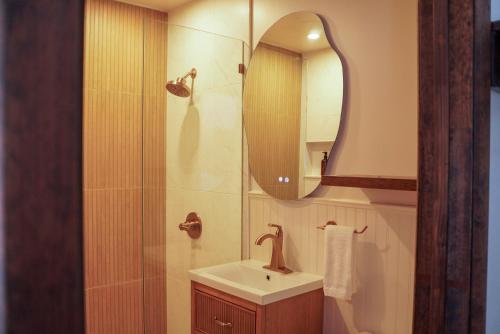 a bathroom with a sink and a mirror at The Perch Hotel in East Windham