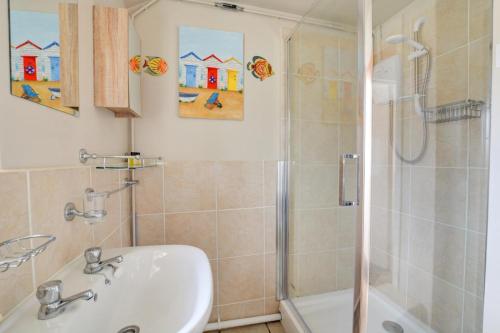 a bathroom with a sink and a shower at 2 Bed in Mundesley oc-673 in Mundesley