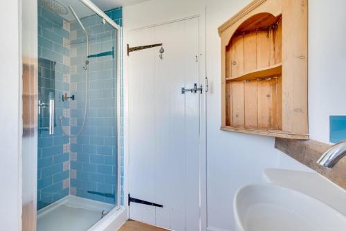 a bathroom with a shower and a sink at 2 Bed in Sweffling oc-whcs in Rendham