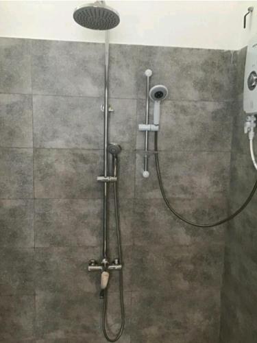 a shower with a shower head in a bathroom at Lucky Palace in Beruwala