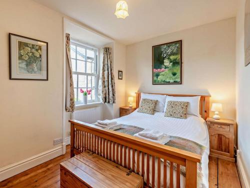 a bedroom with a large bed and a window at 2 Bed in Kirkby Stephen oc-sz144 in Kirkby Stephen