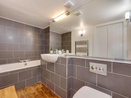 a bathroom with a toilet and a sink and a tub at 5 Bed in Selkirk oc-tower in Selkirk