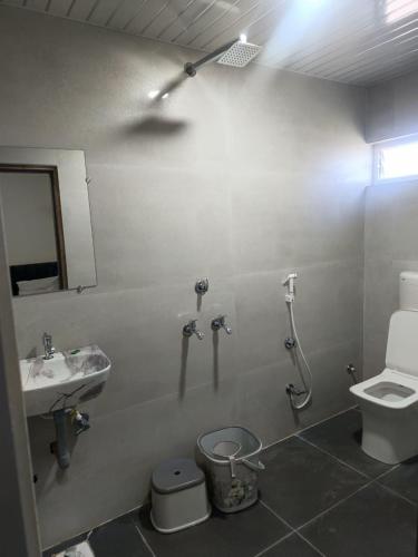 a bathroom with a sink and a toilet and a shower at Hotel Jayaswal INN in Bharbharia