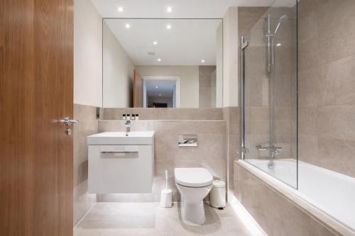 a bathroom with a toilet and a sink and a shower at Roomspace Serviced Apartments - Trinity House in Reigate