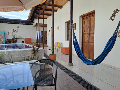 a patio with a hammock in a house at Casa vacacional SAMUEL in Honda