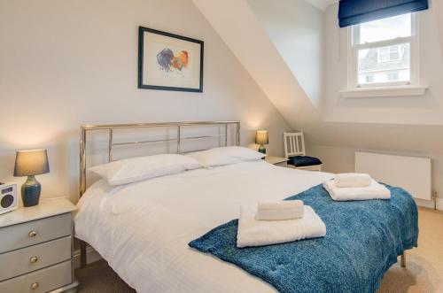 a bedroom with a large bed with two towels on it at 2 Bed in Fowey oc-p00857 in Fowey