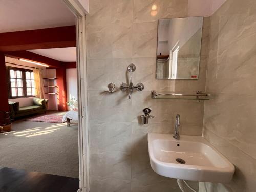 a bathroom with a sink and a mirror at Avalokiteśvara Āvāsa in Kathmandu