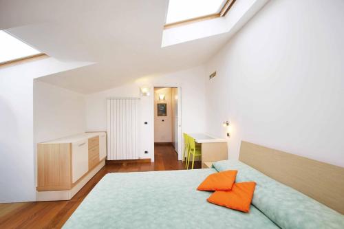 a bedroom with a bed with orange pillows on it at WI-RO Carminati - Mare e relax in Marina di Andora