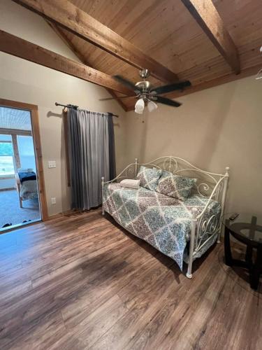 a bedroom with a bed and a ceiling fan at Cottage No 4 on Ranch in McKinney