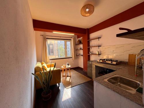 a kitchen with a sink and a counter top at Mandāravā Āvāsa in Kathmandu